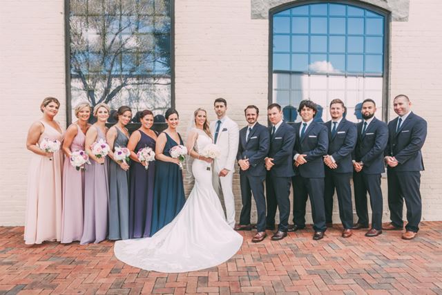 Jon Lei Atelier real bride with her husband and bridal party
